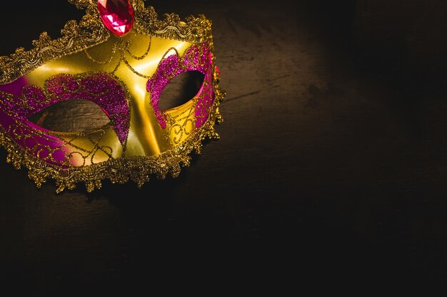 Golden venetian mask on a dark background