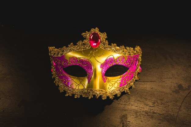 Golden venetian mask on a wooden table