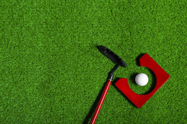 Free photo golf ball and golf club on grass