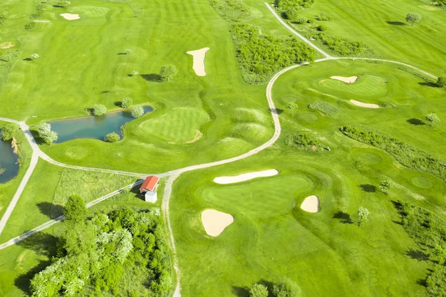 Free photo golf course with sand bunker green grass and pond aerial view