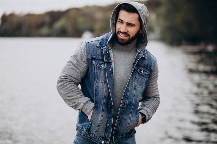 Free Photo good looking bearded man by the river in park