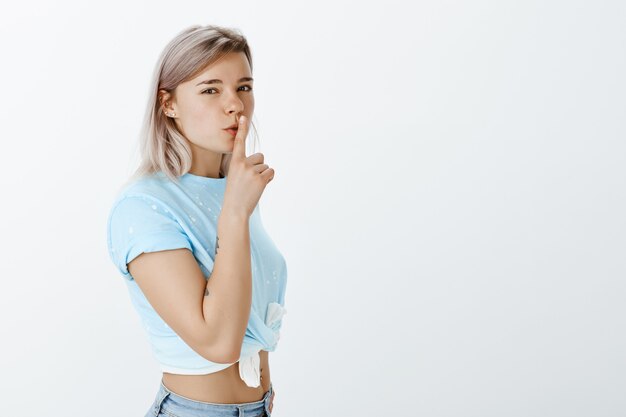 Good-looking blonde girl posing in the studio