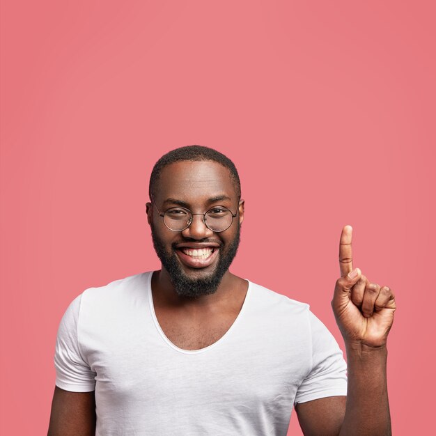 Good looking dark skinned unshaven male with broad smile