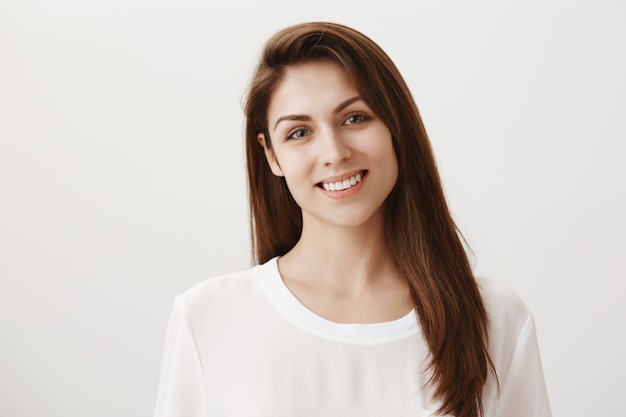 Good-looking smiling woman looking friendly at front