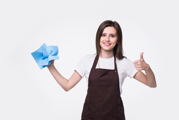 Good-looking woman making a bow-tie out of sponge giving a thumbs-up. Happy cleaner having fun.