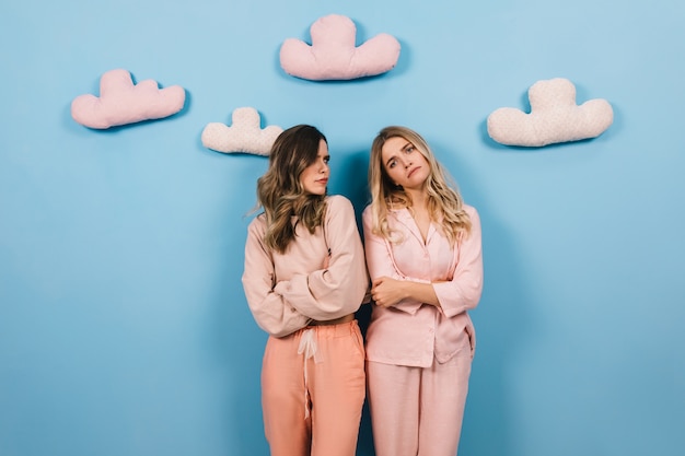 Good-looking women posing in pajamas