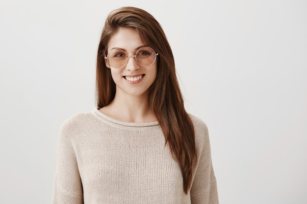 Good-looking young woman in sunglasses smiling