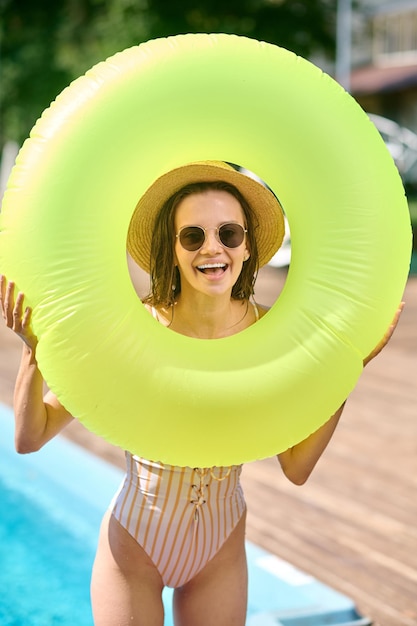 Good mood. Pretty smiling woman with a tube feeling cheerful