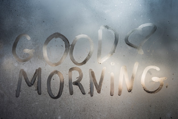 Free photo good morning inscription on sweaty window