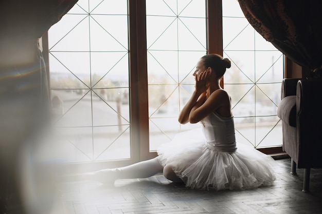 gorgeous ballet dancer. ballerina in pointe. girl by the window.