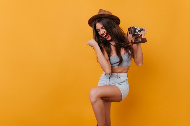 Gorgeous dark-haired girl with camera expressing positive emotions