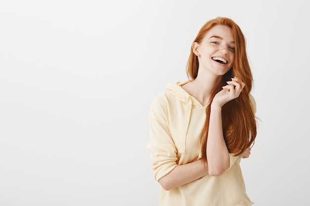 Gorgeous happy redhead girl smiling and laughing carefree