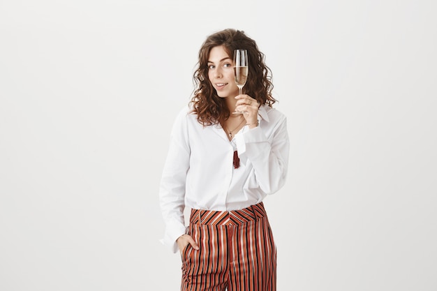 Gorgeous happy woman enjoying party with glass champagne