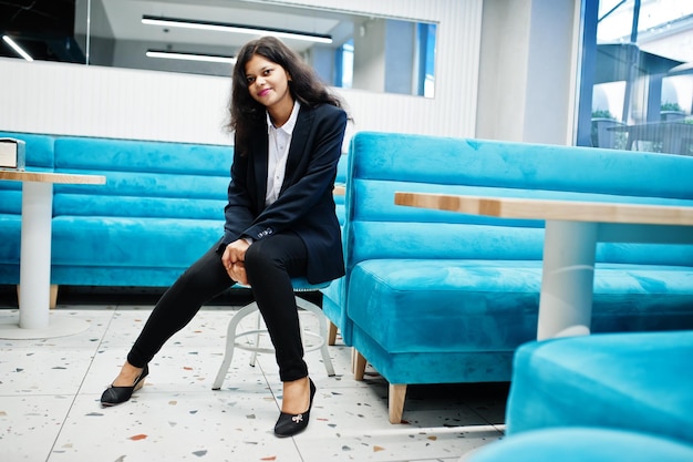 Gorgeous indian woman wear formal posing at cafe