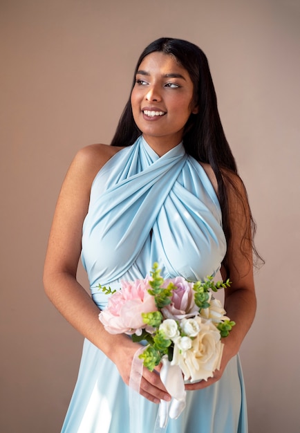 Free photo gorgeous portrait of bridesmaid with flower boquete