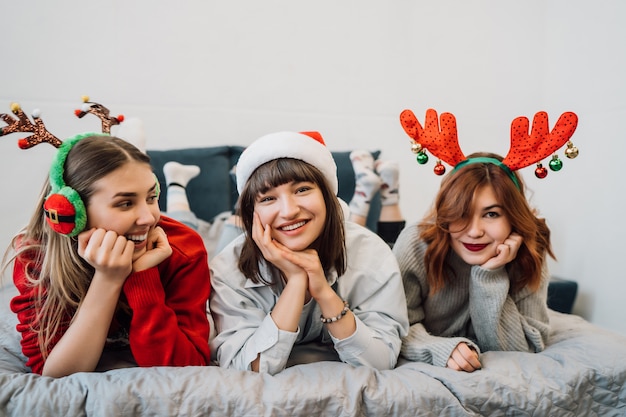 Gorgeous smiling friends having fun and enjoying pajamas party