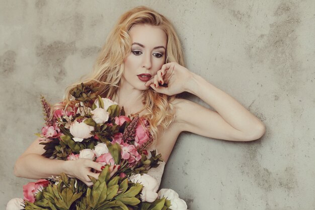 Gorgeous woman holding roses bouquet