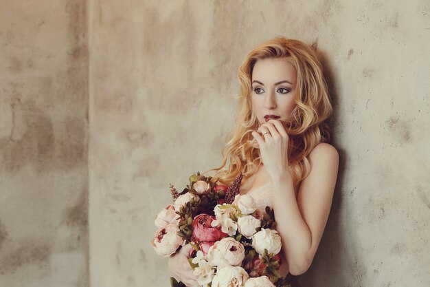 Gorgeous woman holding roses bouquet