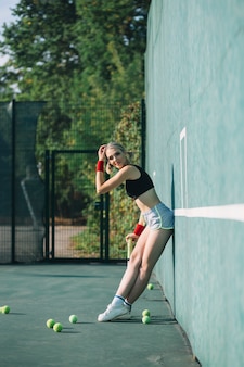 Gorgeous woman playing on a tennis field