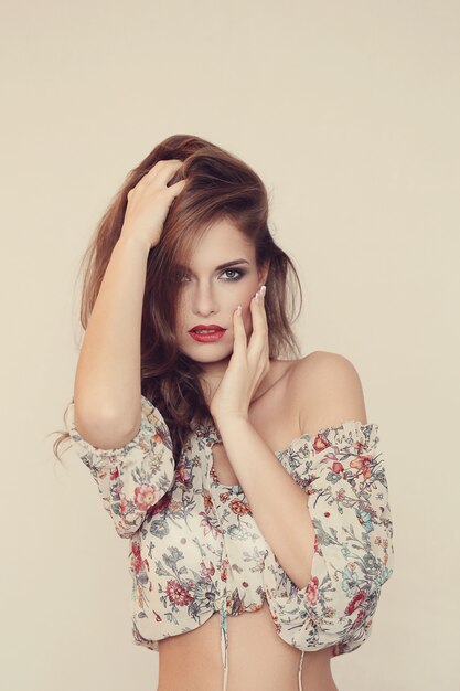 Gorgeous woman posing with floral top, summer fashion concept