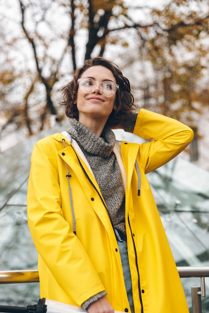 Gorgeous woman with beautiful curly hair walking through city center on weekend taking pleasure while spending time alone