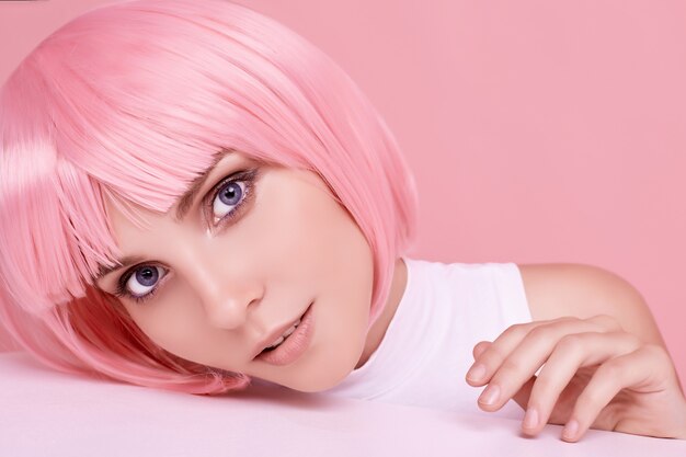 Gorgeous woman with pink hair posing