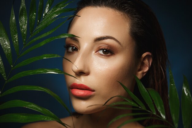 Gorgeous woman with wet slicked back hair looking straight.