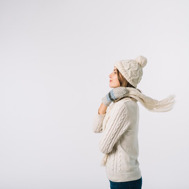 Gorgeous woman wrapping scarf around neck