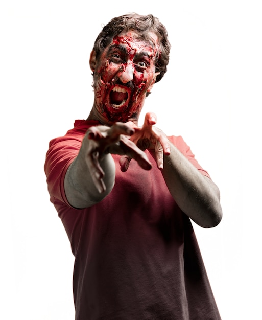 Gory zombie screaming with raised arms