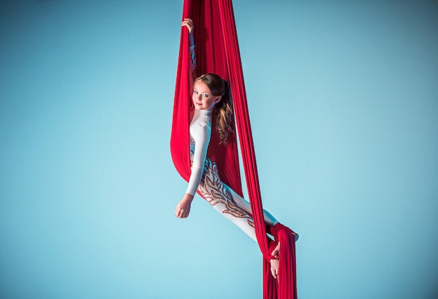 Graceful gymnast performing aerial exercise