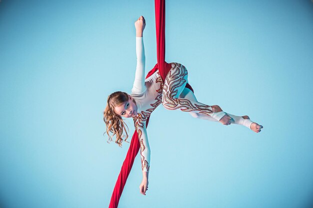 Graceful gymnast performing aerial exercise