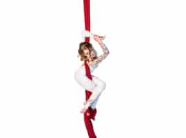 Free photo graceful gymnast performing aerial exercises with red fabrics on white background