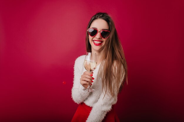 Graceful lady in funny glasses celebrating something