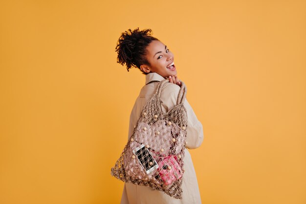 Graceful woman posing with string bag