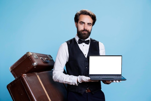 Free photo gracious bellboy holds laptop