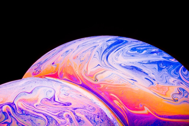 Gradient abstract soap bubbles on black background