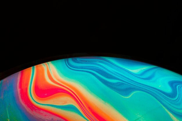 Gradient colorful smooth soap bubble on black background