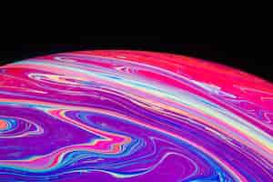 Free photo gradient colorful soap bubble on black background