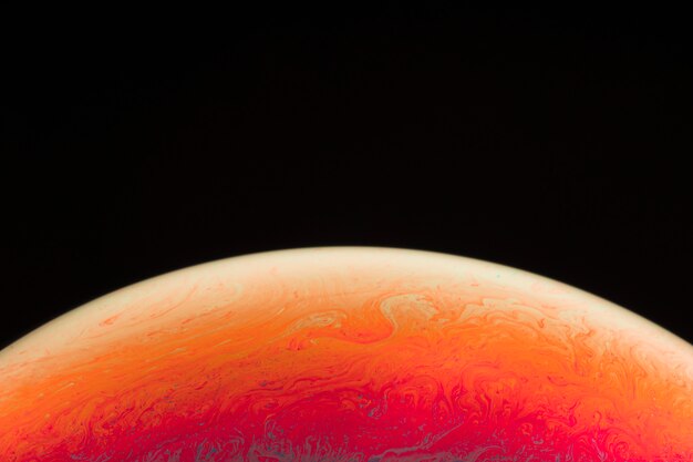 gradient colorful soap bubble on black background