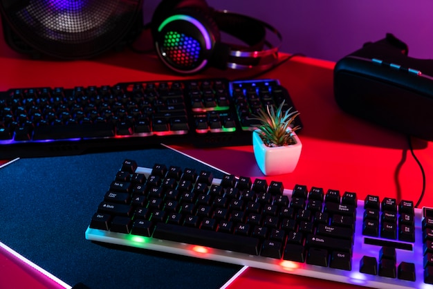 Gradient illuminated neon gaming desk setup with keyboard