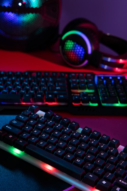 Gradient illuminated neon gaming desk setup with keyboard