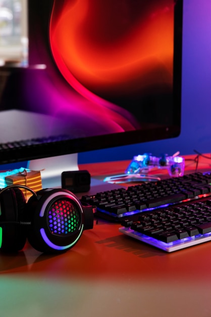 Gradient illuminated neon gaming desk setup with keyboard