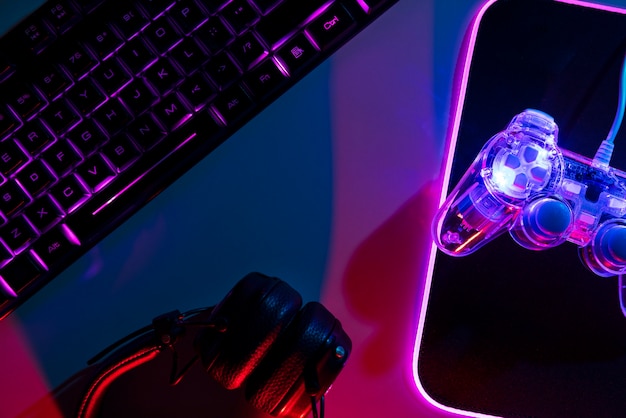 Gradient illuminated neon gaming desk setup with keyboard