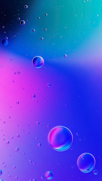 Free photo gradient iphone wallpaper oil bubble in water background