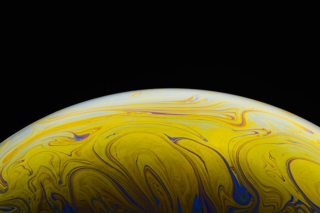 Gradient smooth soap bubble on black background