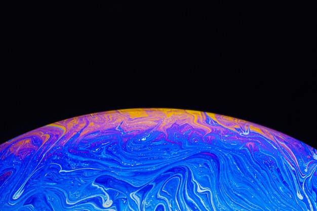 Gradient soap bubble on black background