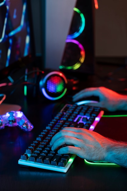 Gradient view of illuminated neon gaming desk setup with keyboard