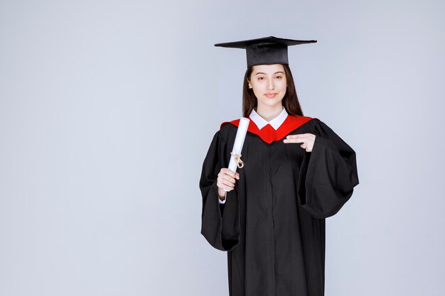 Graduate female student with diploma celebration successful college graduation. High quality photo