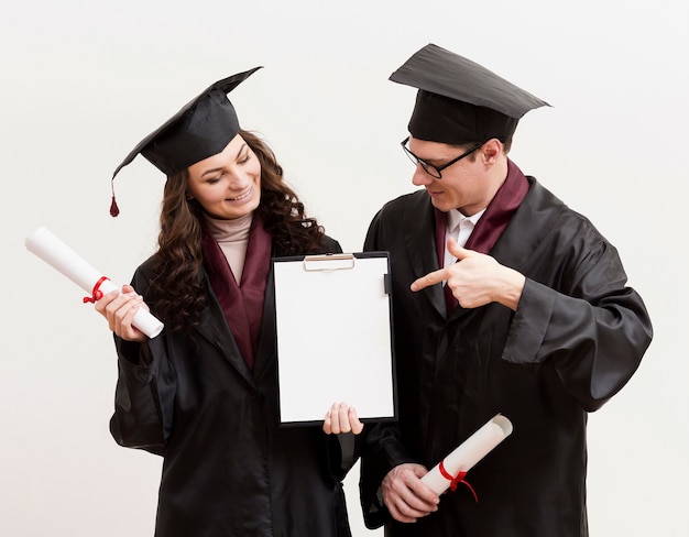 Graduate students holding clipboard