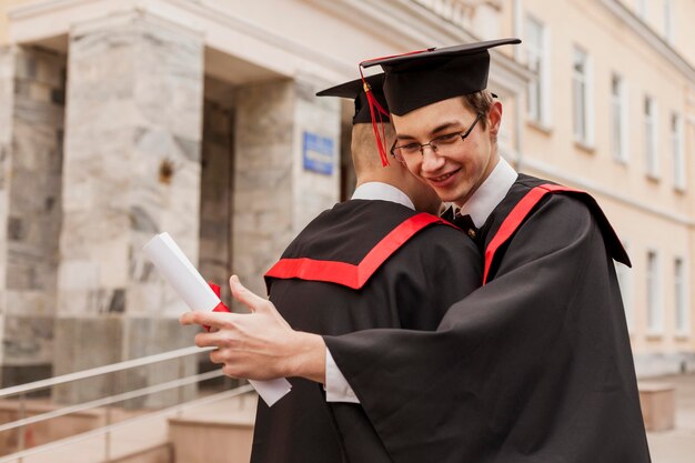 Graduated boys hugging